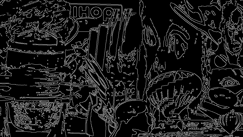 incomprehensible mess of white lines on black. baby grinch is there, kind of. you can see the ihop logo buried under all of it. hot air balloon. a bisected face.